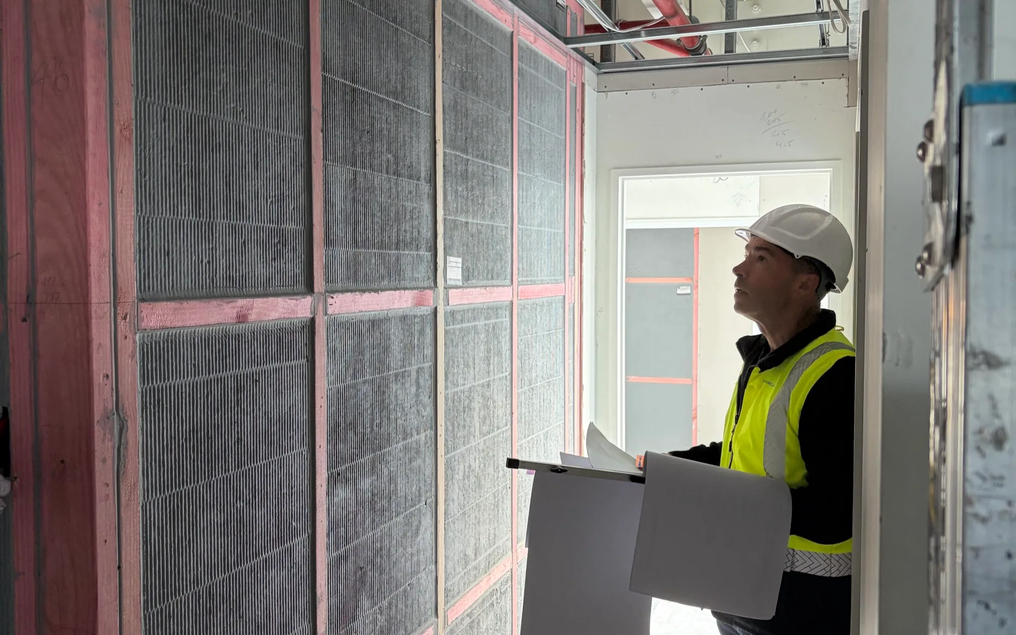 A FormeProjects site inspection in progress, checking installed fire-rated floor panels against documentation